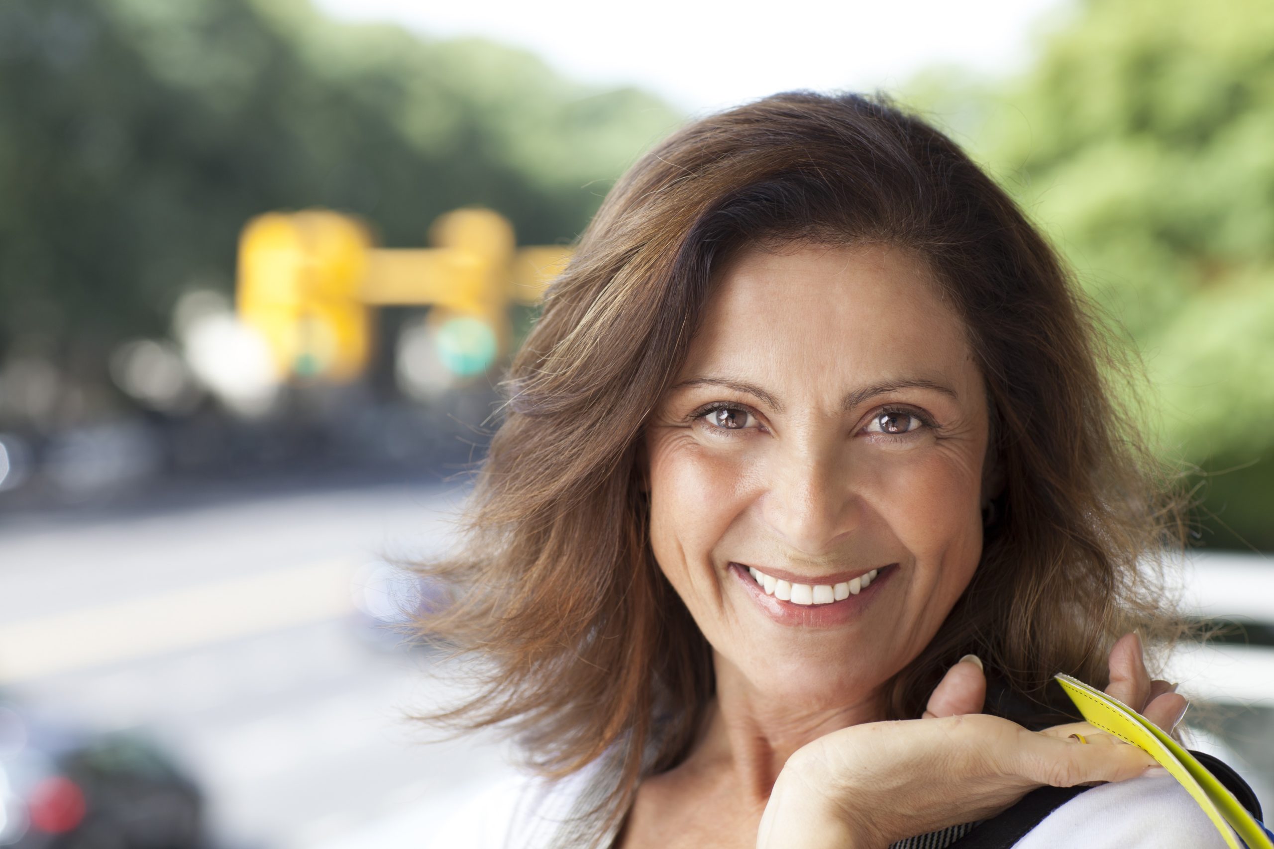 Middle,Age,Woman,Smiling,And,Looking,At,Camera